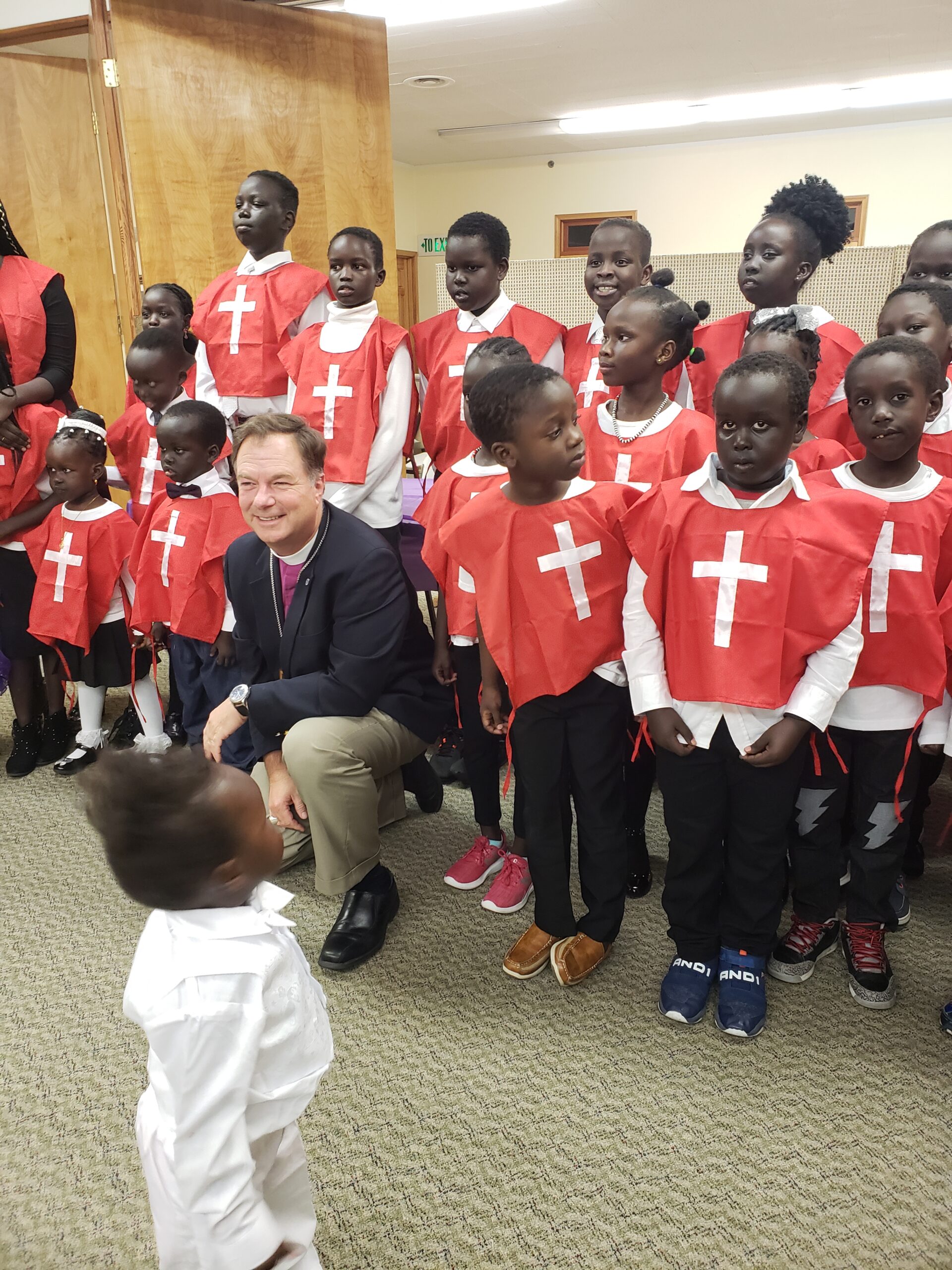 Bishop Rickel with youth from St. John's South Sudanese Church.